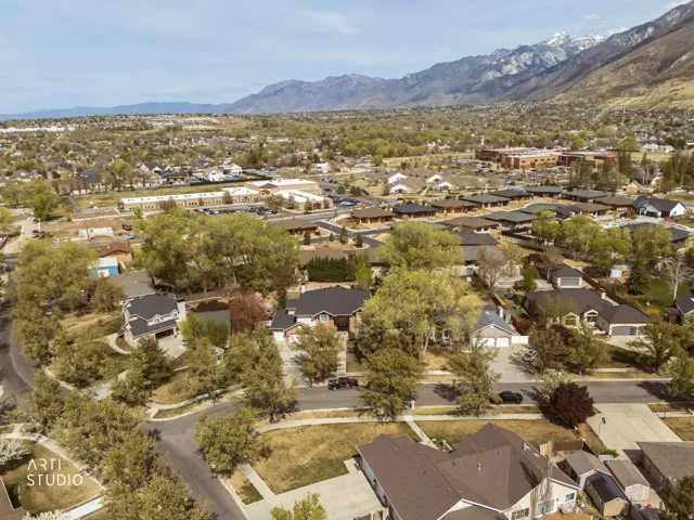 Aerial view of property's location featuring nearby suburban area and a mountainous background