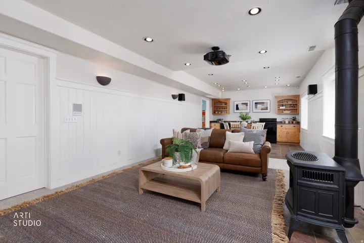 Living area featuring recessed lighting, a wainscoted wall, and a wood stove