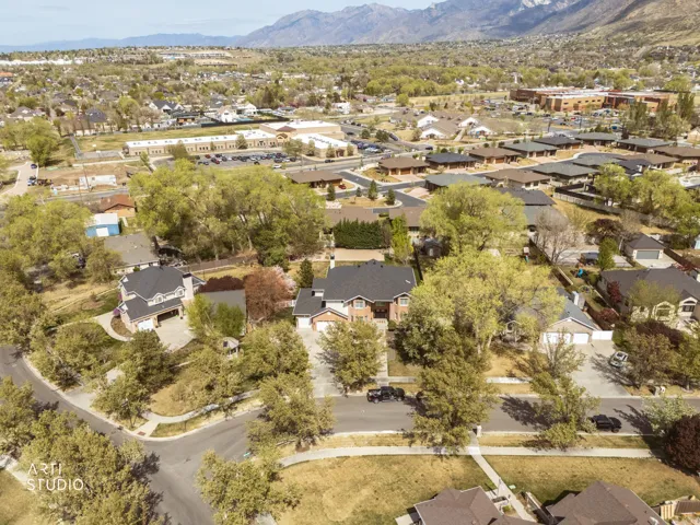Aerial view of property's location with nearby suburban area and a mountainous background