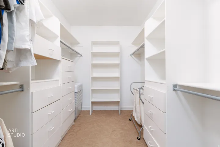Walk in closet featuring light carpet