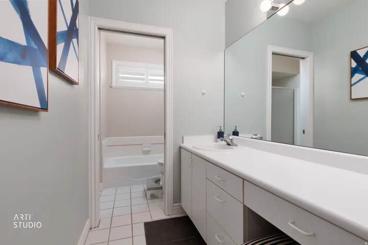 Bathroom with vanity, a bath, a shower, and light tile patterned floors