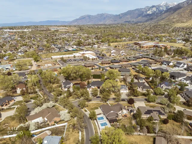 Aerial view of property's location with nearby suburban area and mountains