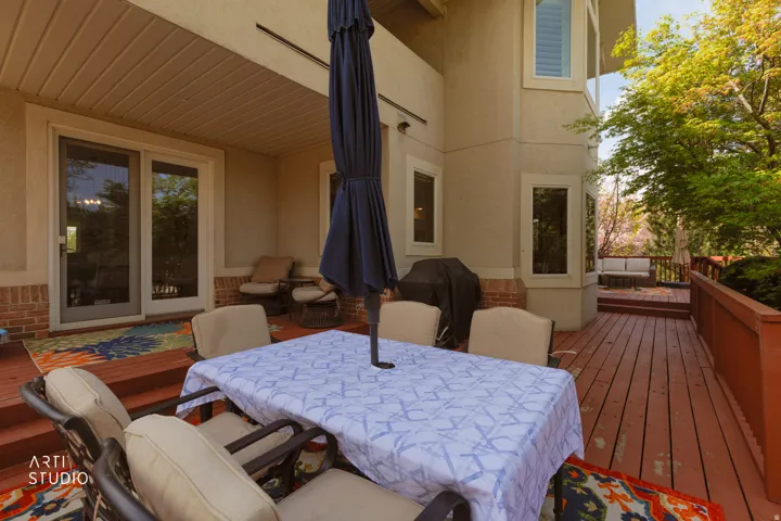 Wooden terrace featuring outdoor dining area and grilling area