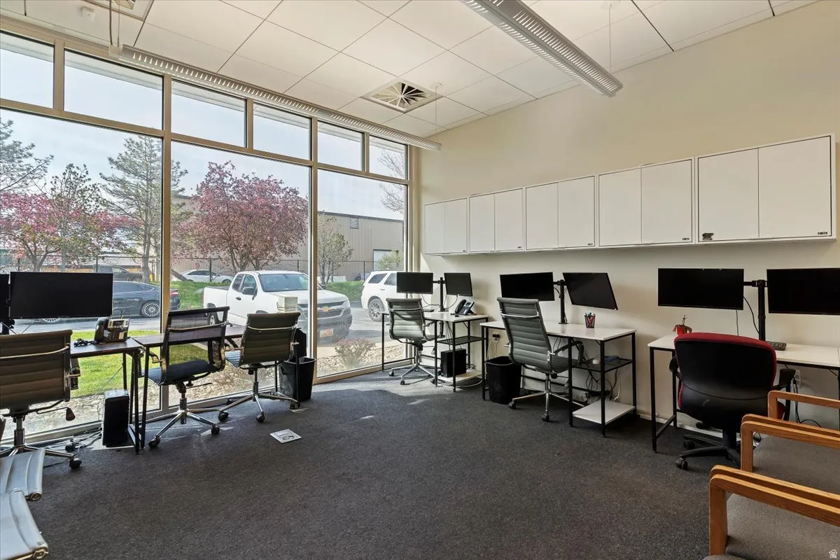 Office with a high ceiling and expansive windows