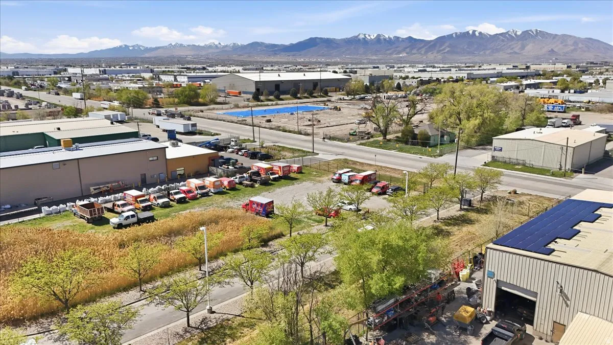 Aerial view of a mountain backdrop and an industrial area