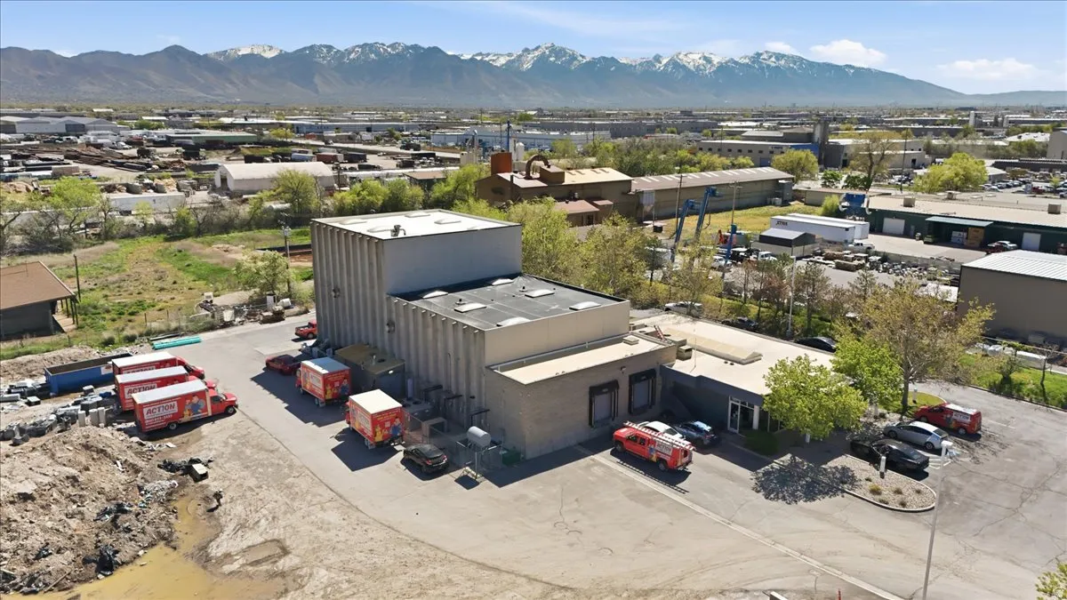 Aerial view of industrial structures and a mountainous background