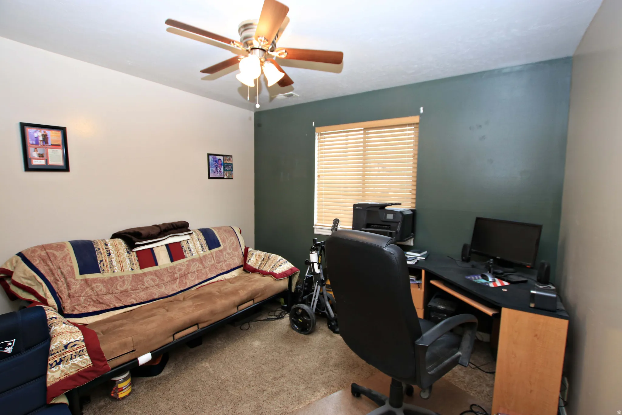 Office with carpet flooring and ceiling fan
