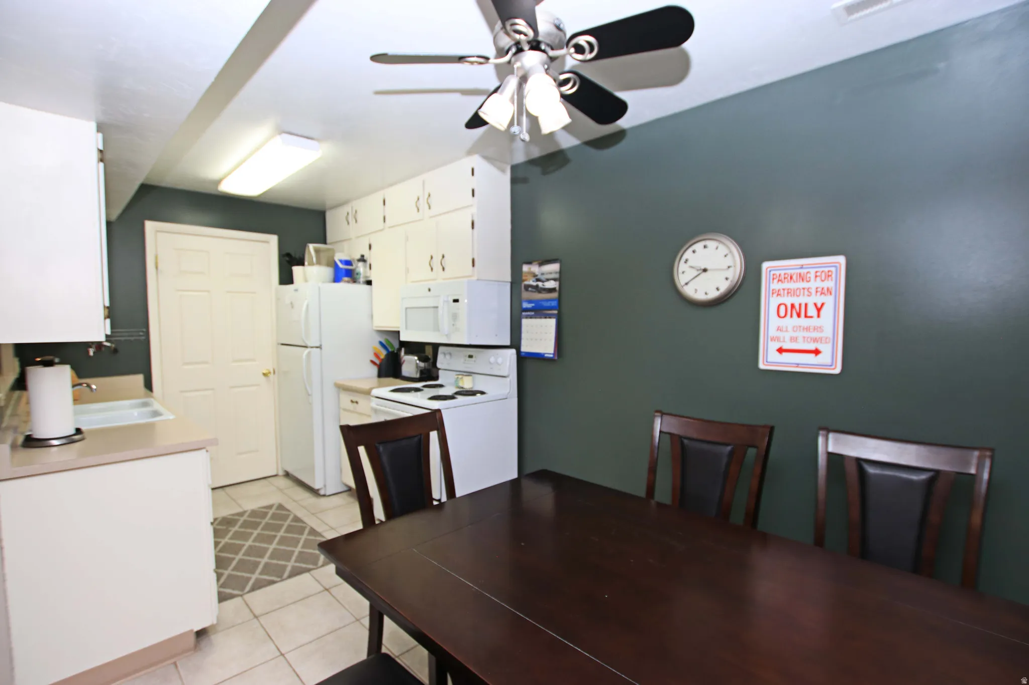 Dining area with ceiling fan and light tile patterned floors