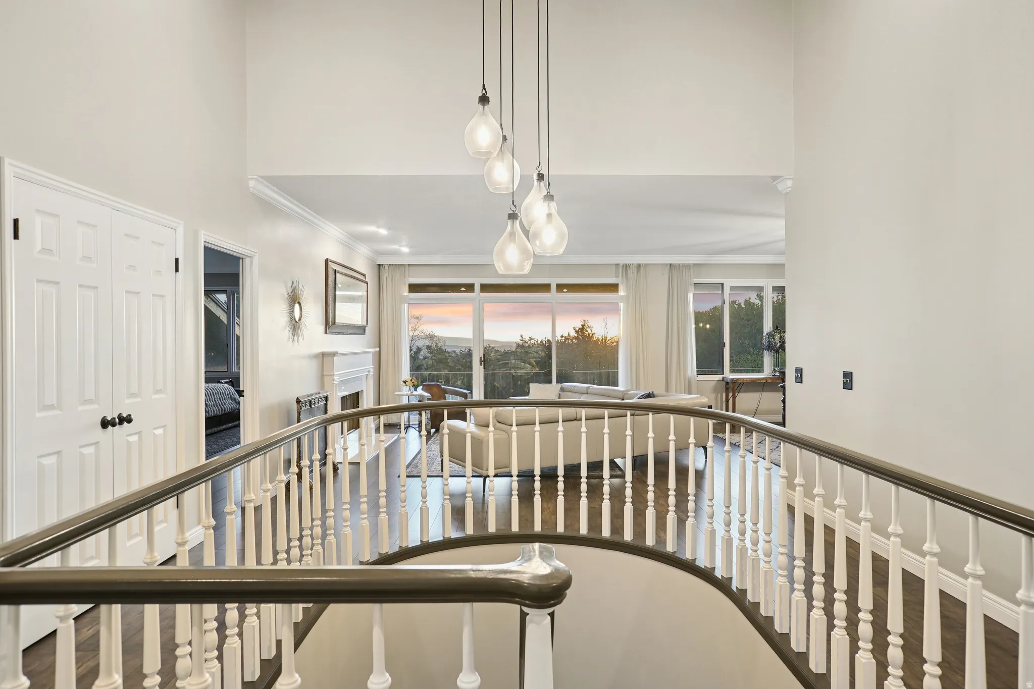 Hallway with crown molding and a high ceiling