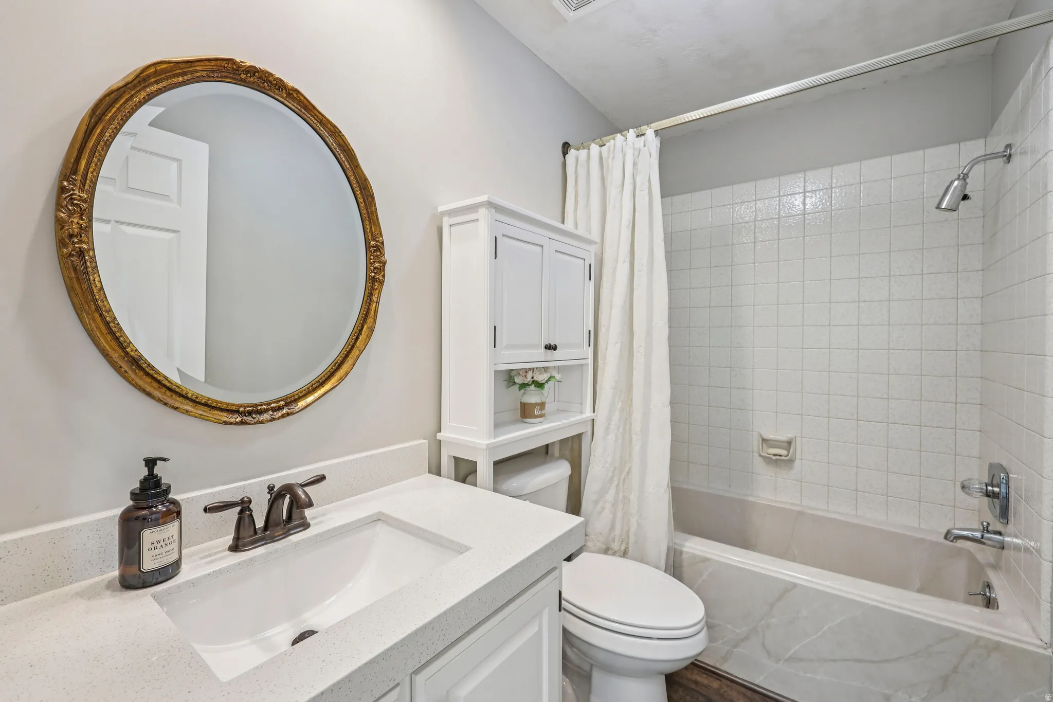 Full bathroom featuring vanity and shower / bath combination with curtain