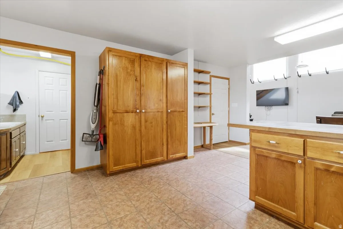 Kitchen featuring wood finish cabinets and open shelves