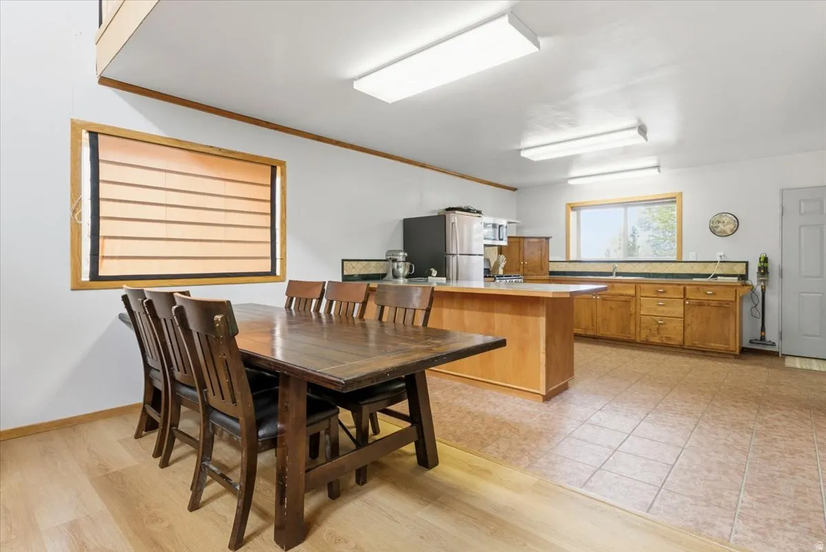 Dining room with crown molding and light wood-style flooring