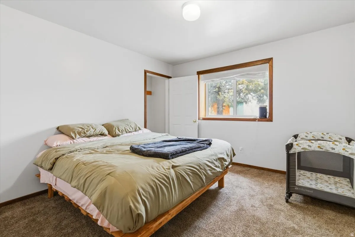 Bedroom with carpet flooring and baseboards