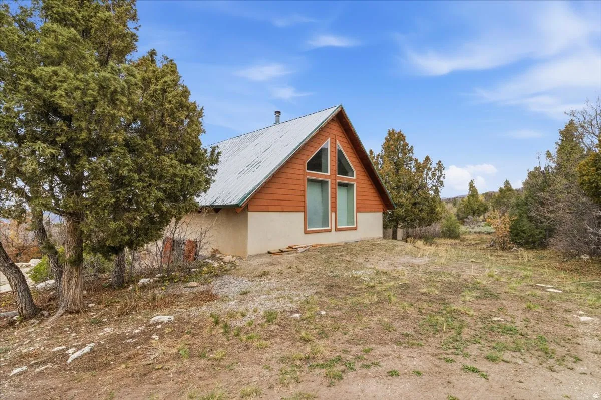 View of property exterior with a metal roof