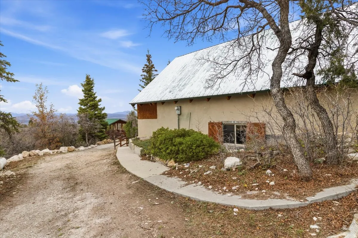 View of property exterior with stucco siding and a metal roof