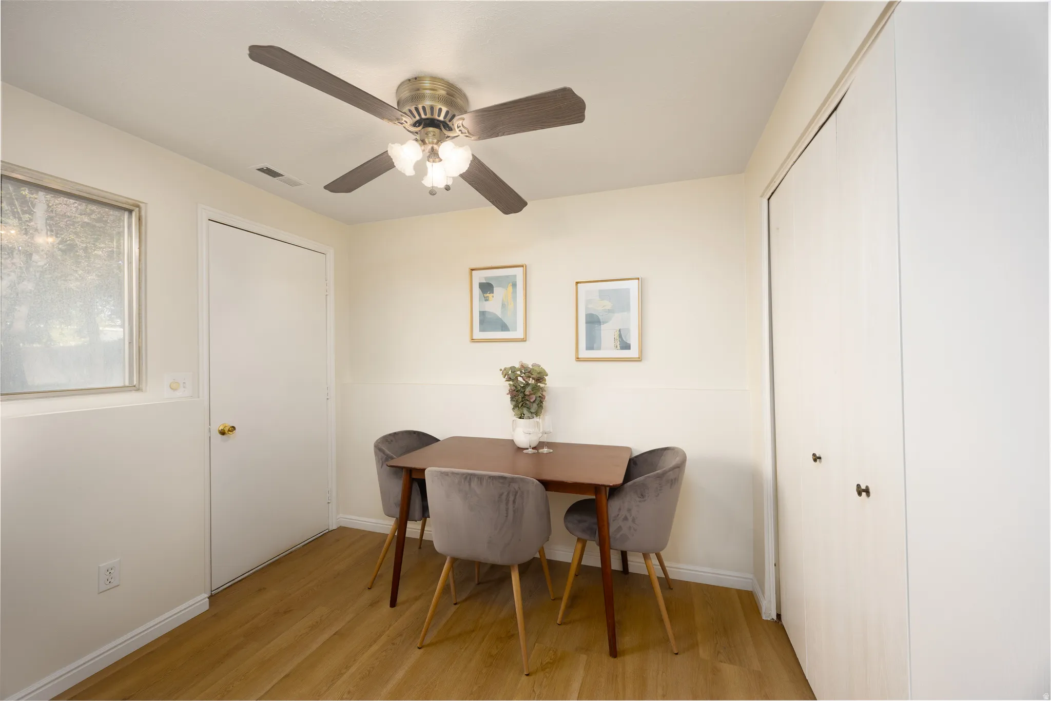 Dining space with light wood finished floors and ceiling fan