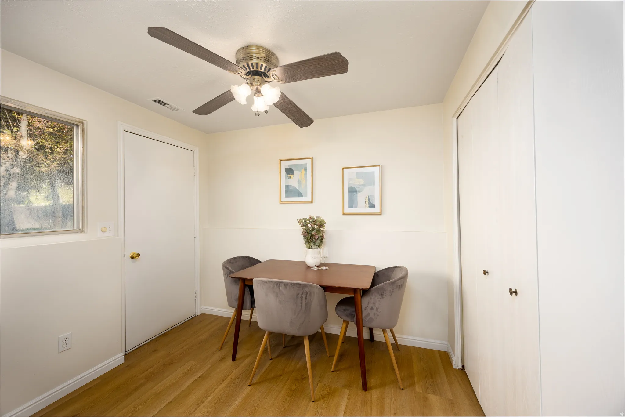 Dining room with light wood-style flooring and a ceiling fan