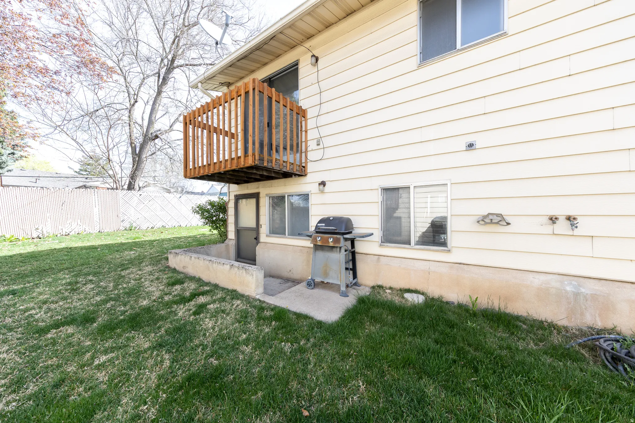 Exterior space featuring a patio and a balcony