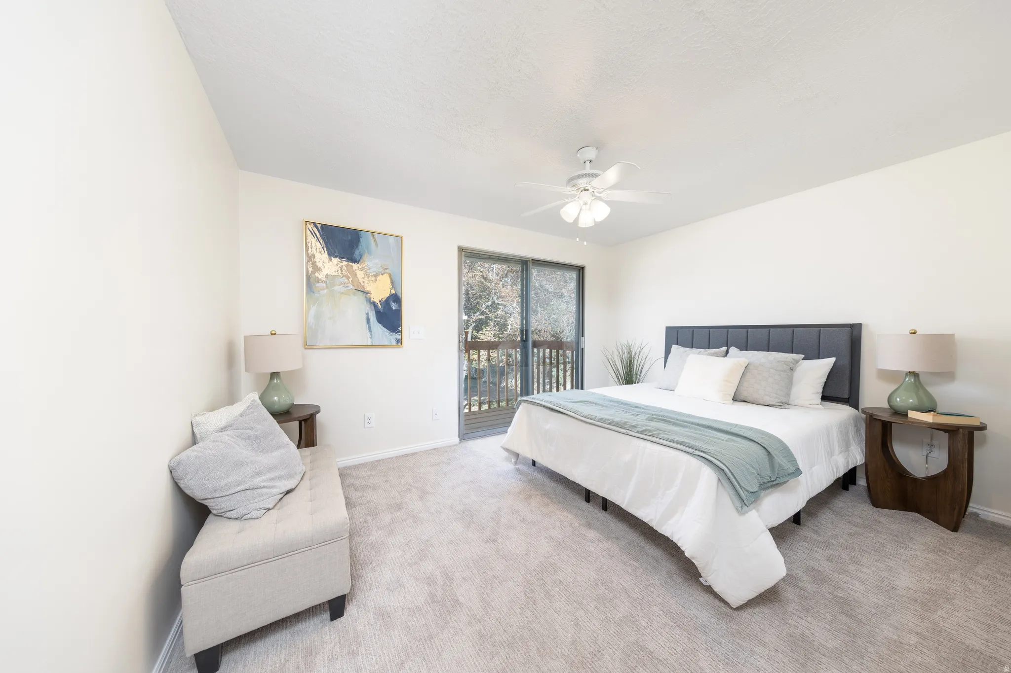 Carpeted bedroom with access to exterior and ceiling fan