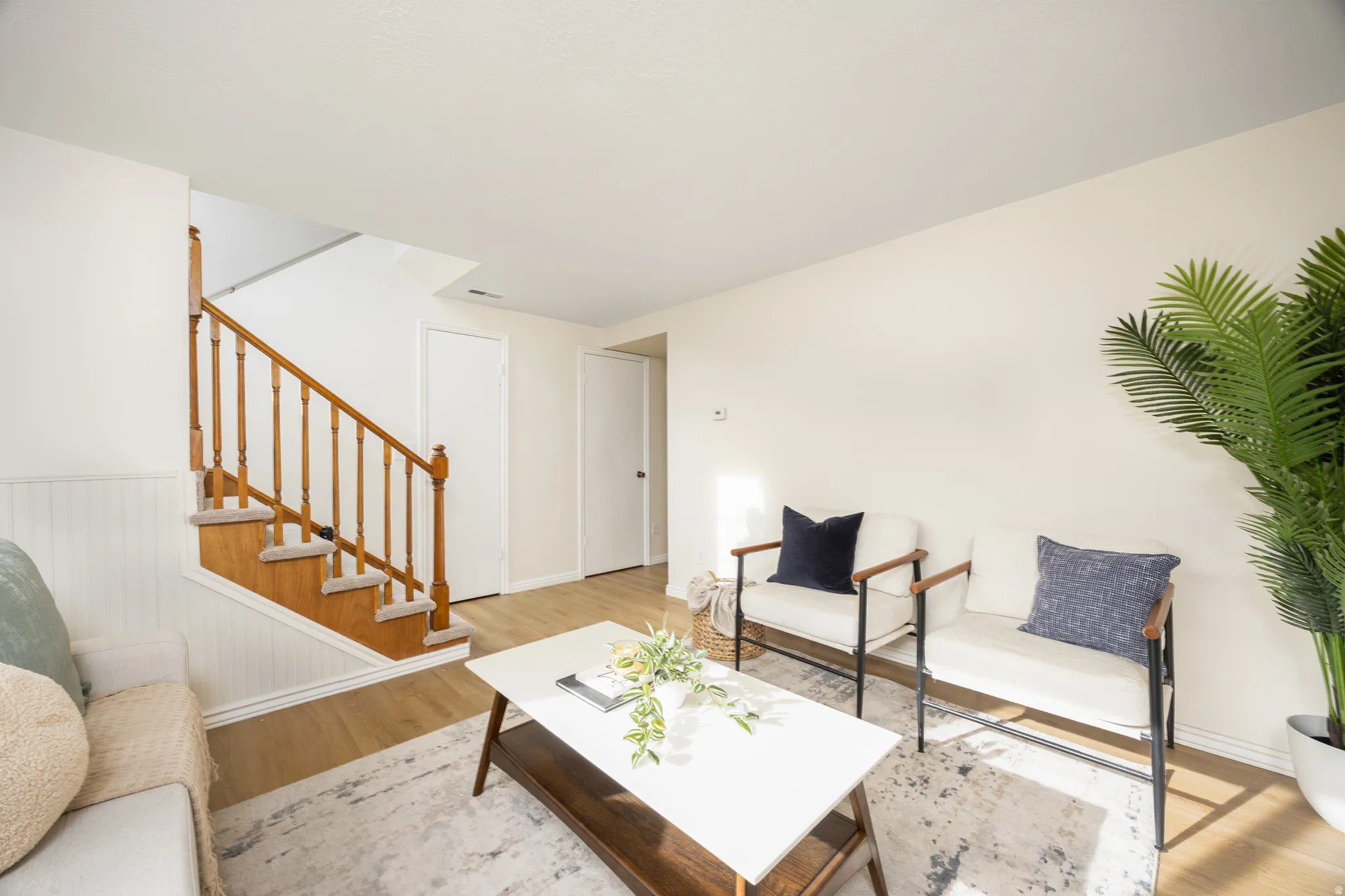 Living room featuring stairway and light wood-type flooring