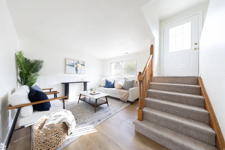Living area featuring light wood-style flooring and a wainscoted wall