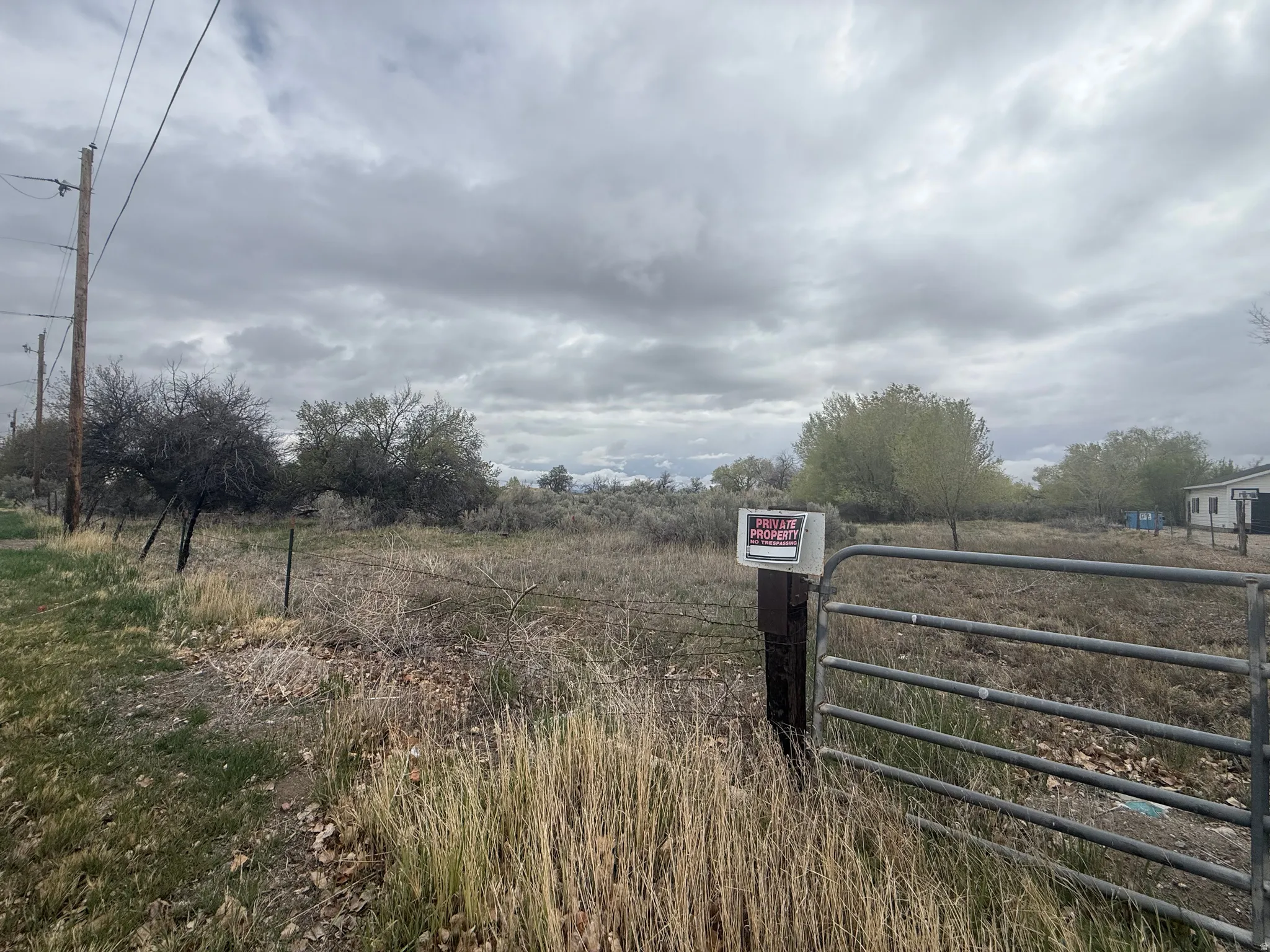 View of road featuring a gate, a gated entry, and a view of countryside