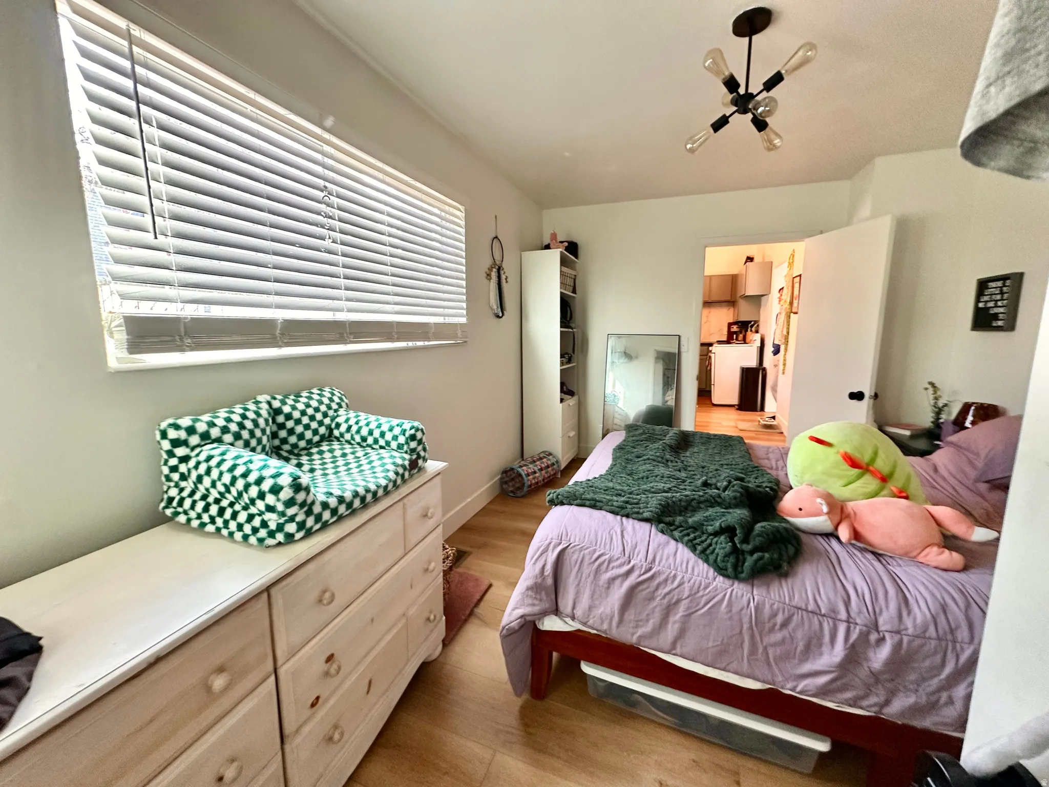 Bedroom with light wood finished floors and baseboards
