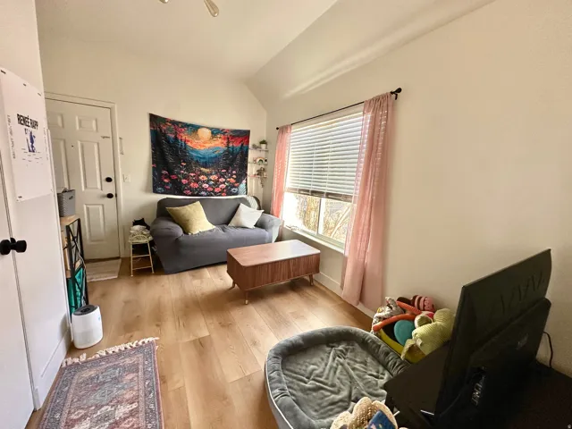 Sitting room featuring lofted ceiling and light wood finished floors