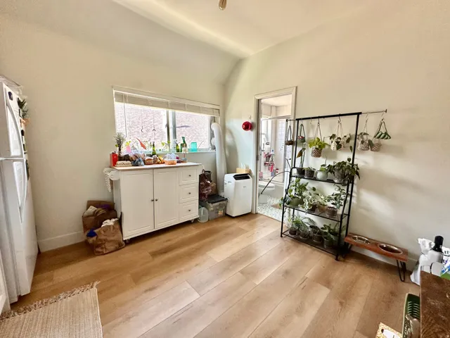 Dining area with light wood-style flooring and lofted ceiling