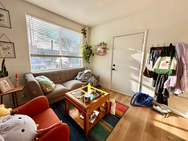 Living room with light wood-style flooring and baseboards