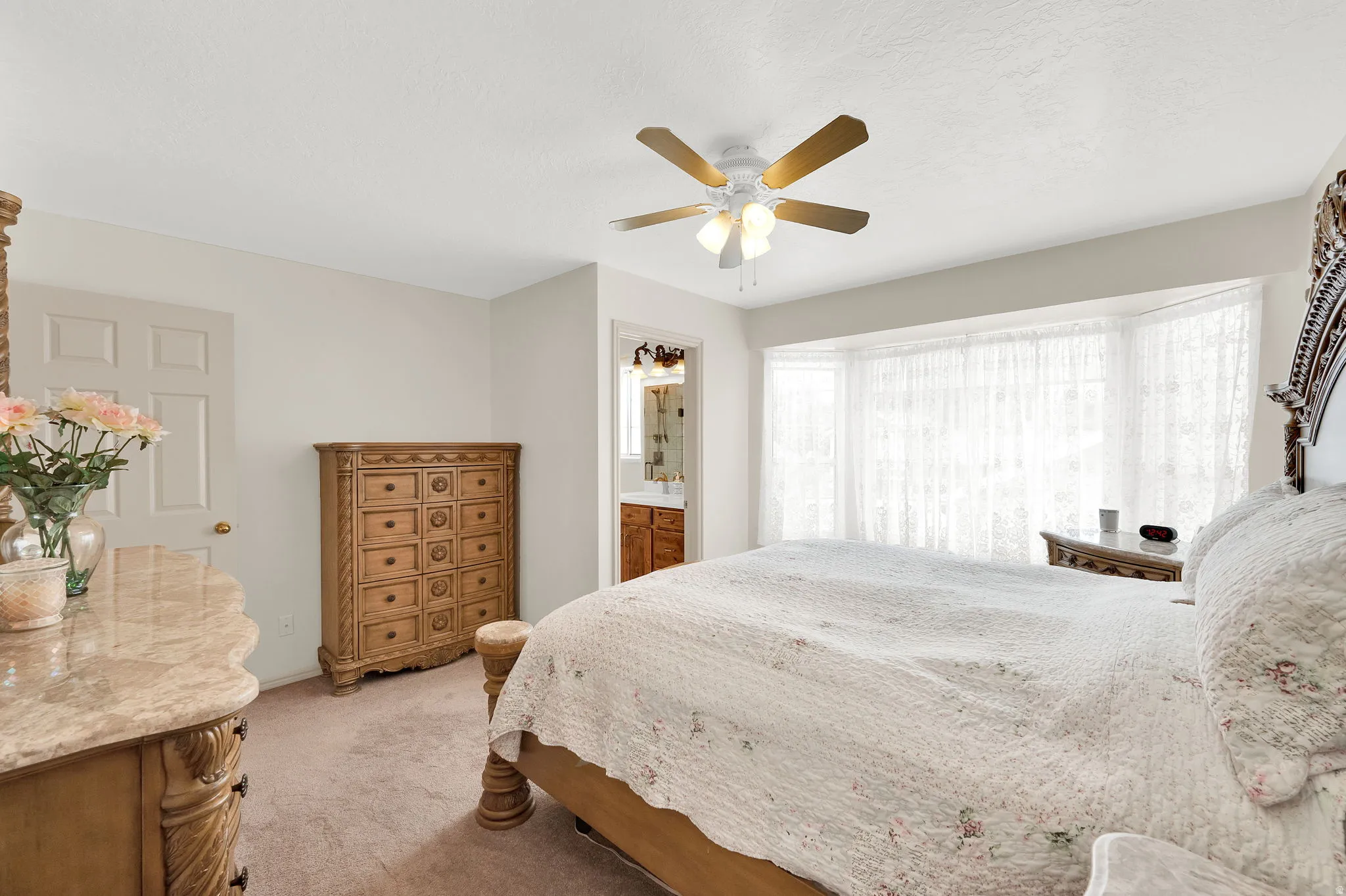 Bedroom featuring light carpet and a ceiling fan