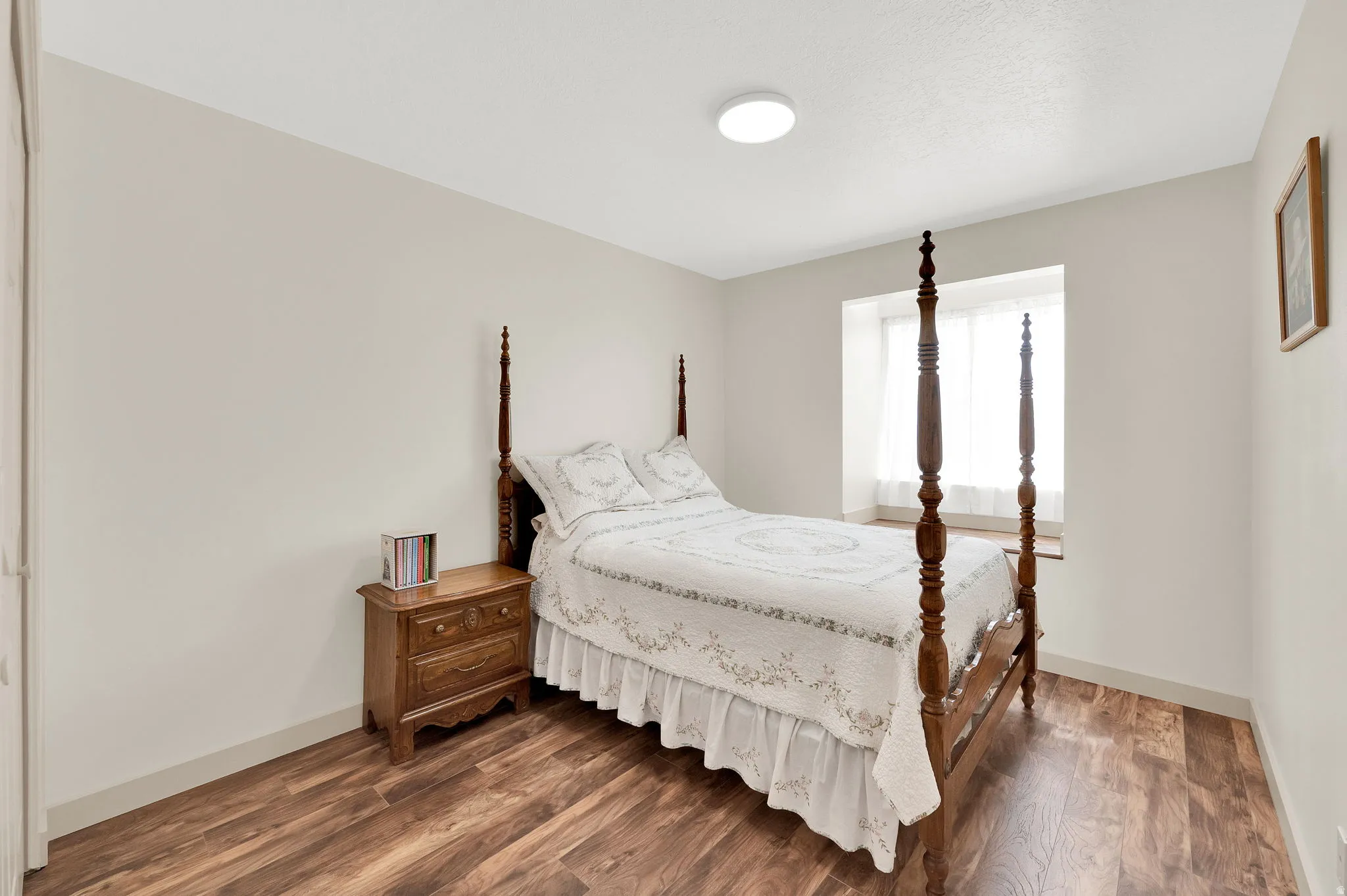 Bedroom featuring dark wood finished floors and baseboards