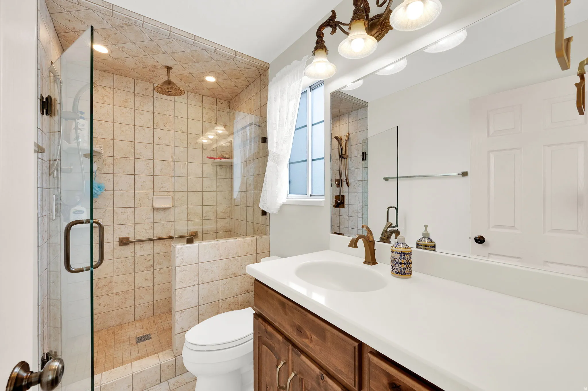 Bathroom with vanity, a shower stall, and recessed lighting
