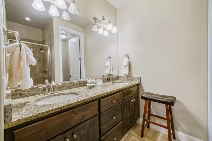 Bathroom with double vanity and a shower stall