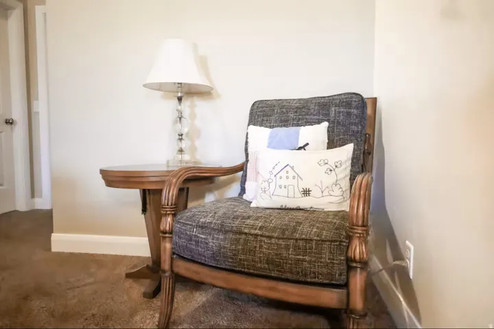 Living area with baseboards and carpet floors