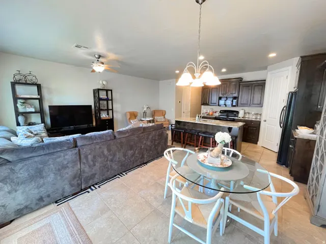 Dining space with hanging lights, a ceiling fan, and light tile patterned flooring
