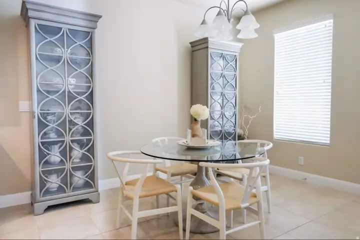 Dining room with suspended lighting and light tile patterned flooring