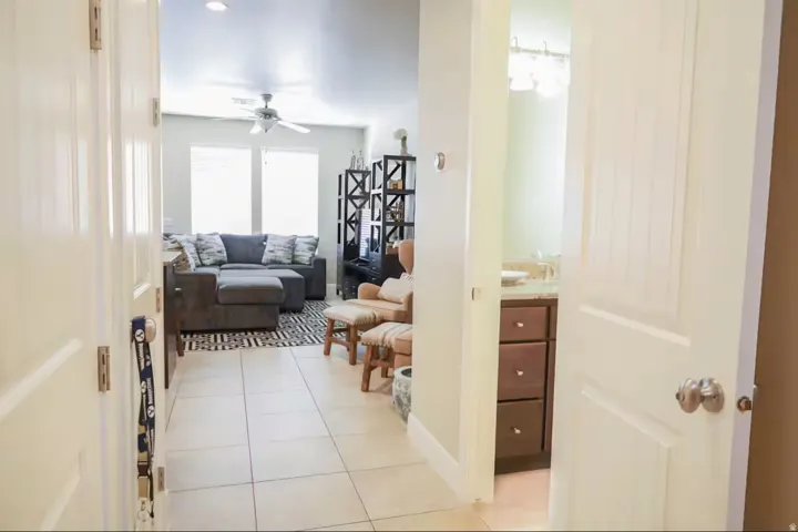 Hallway with light tile patterned flooring