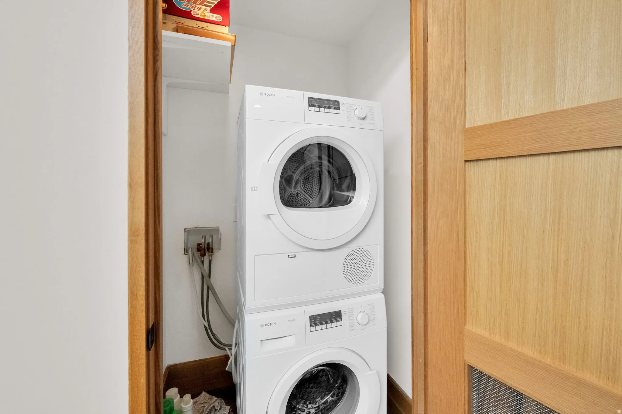 Laundry area with stacked washing machine and dryer