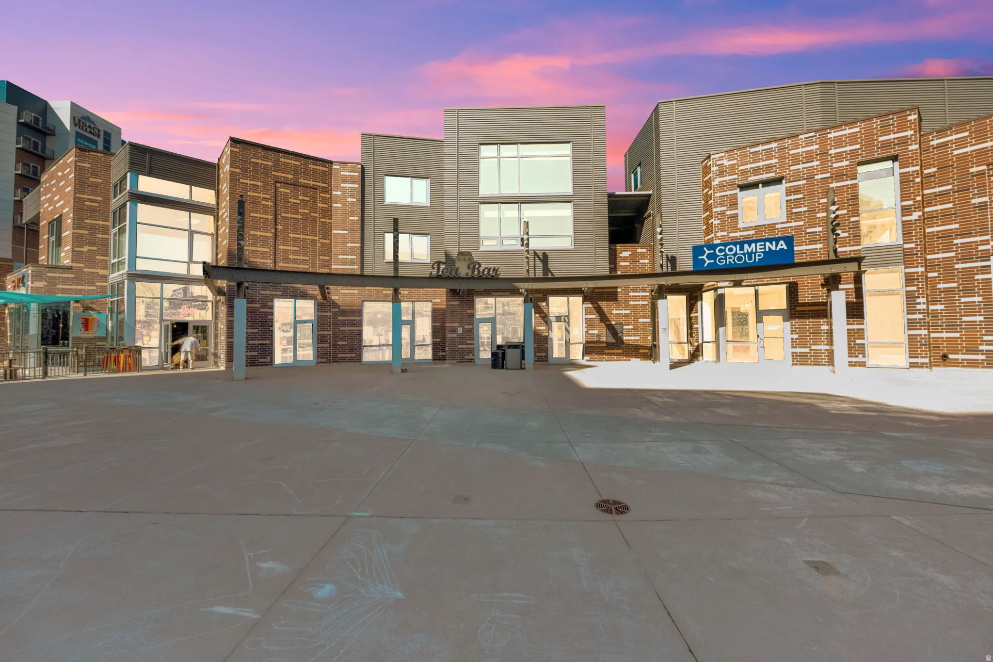 Property at dusk featuring view of commercial area