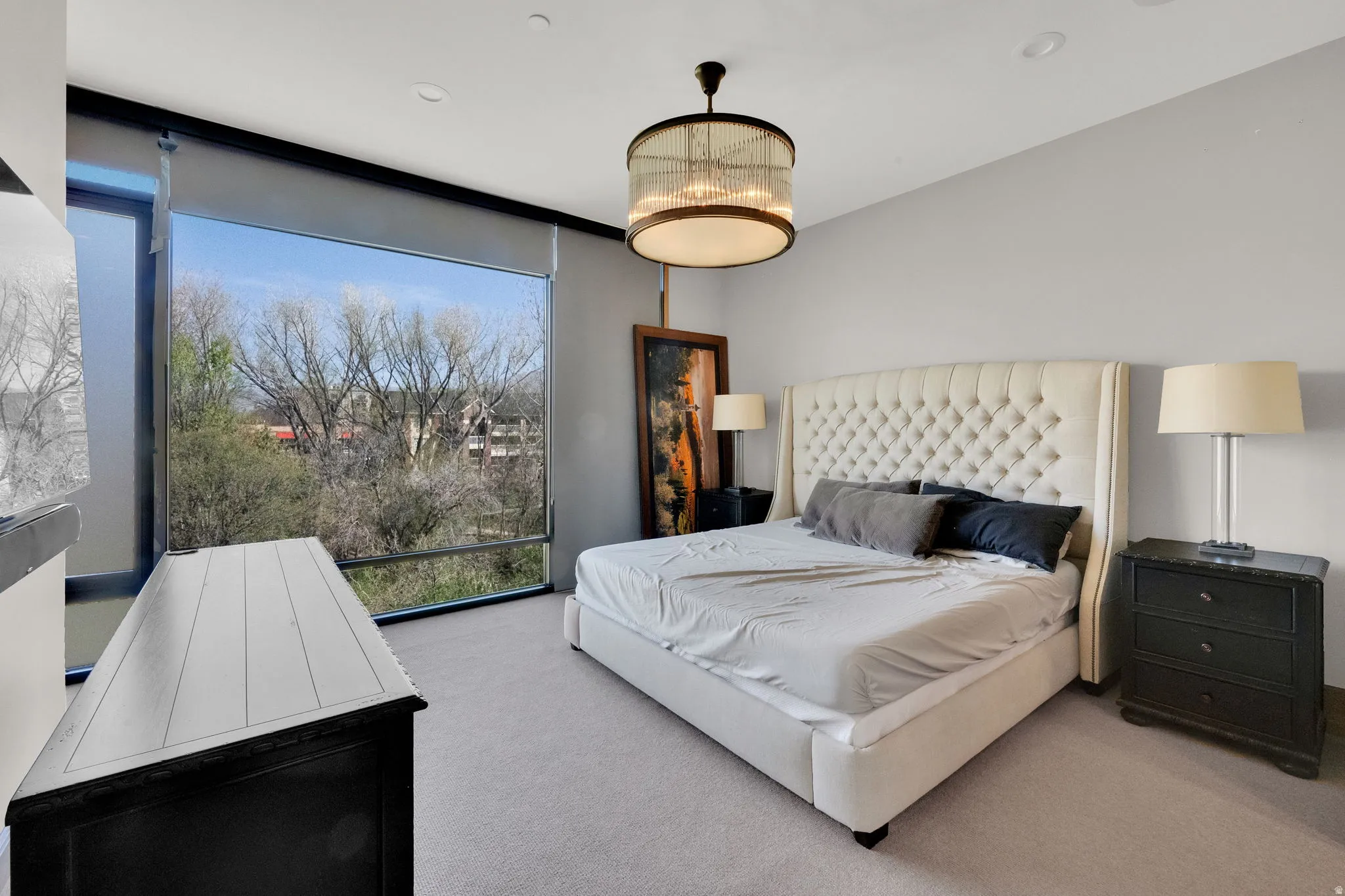 Bedroom with light carpet, expansive windows, and recessed lighting
