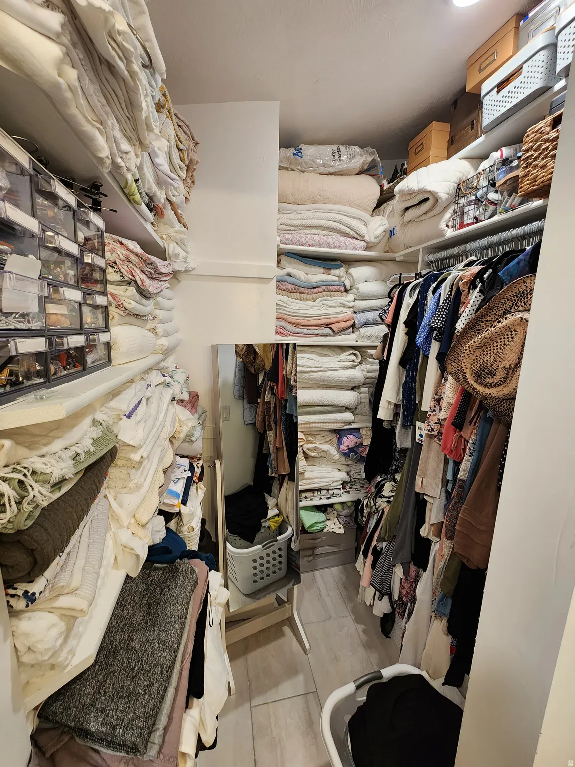 Walk in closet with light wood finished floors
