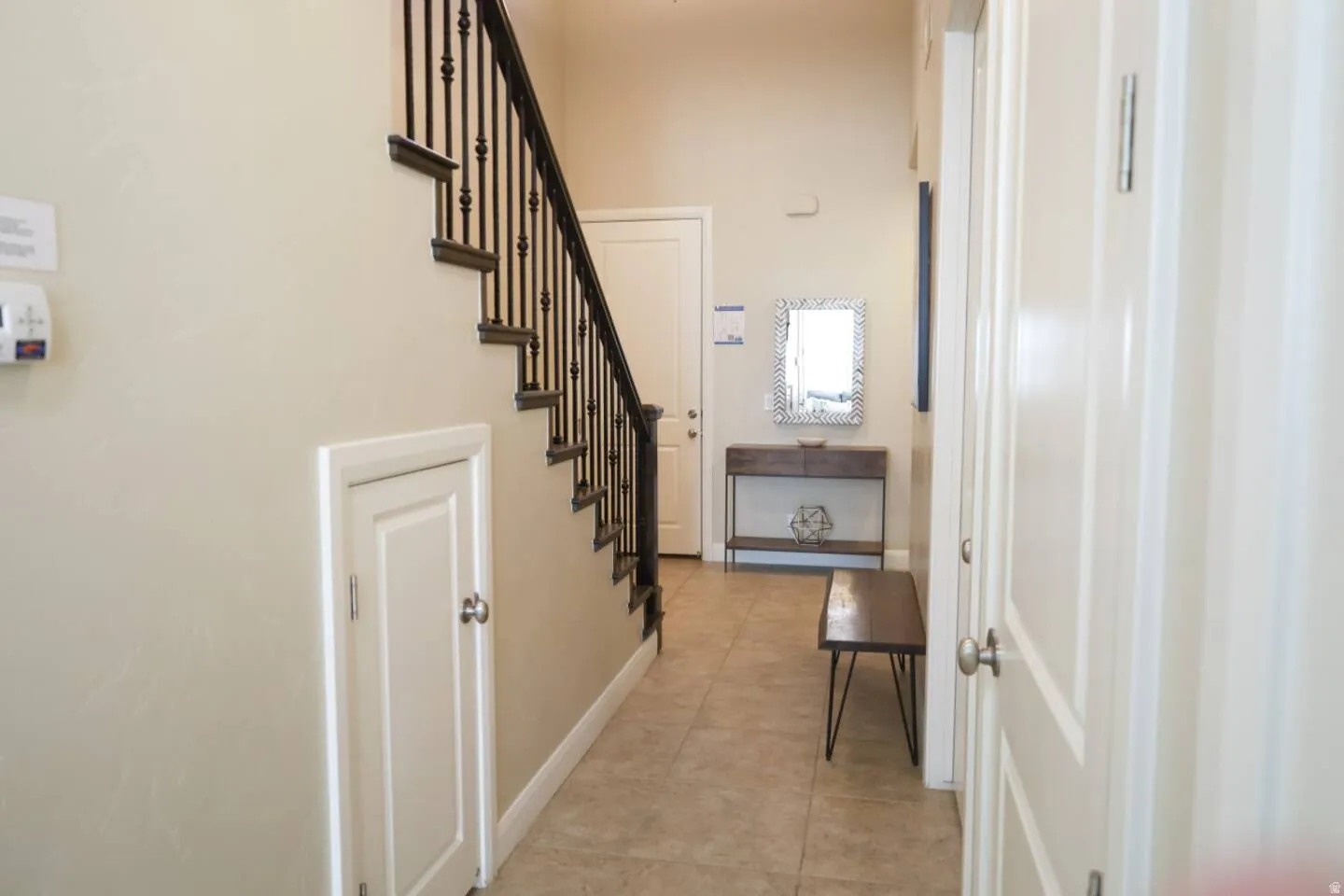 Entryway featuring stairway and light tile patterned floors