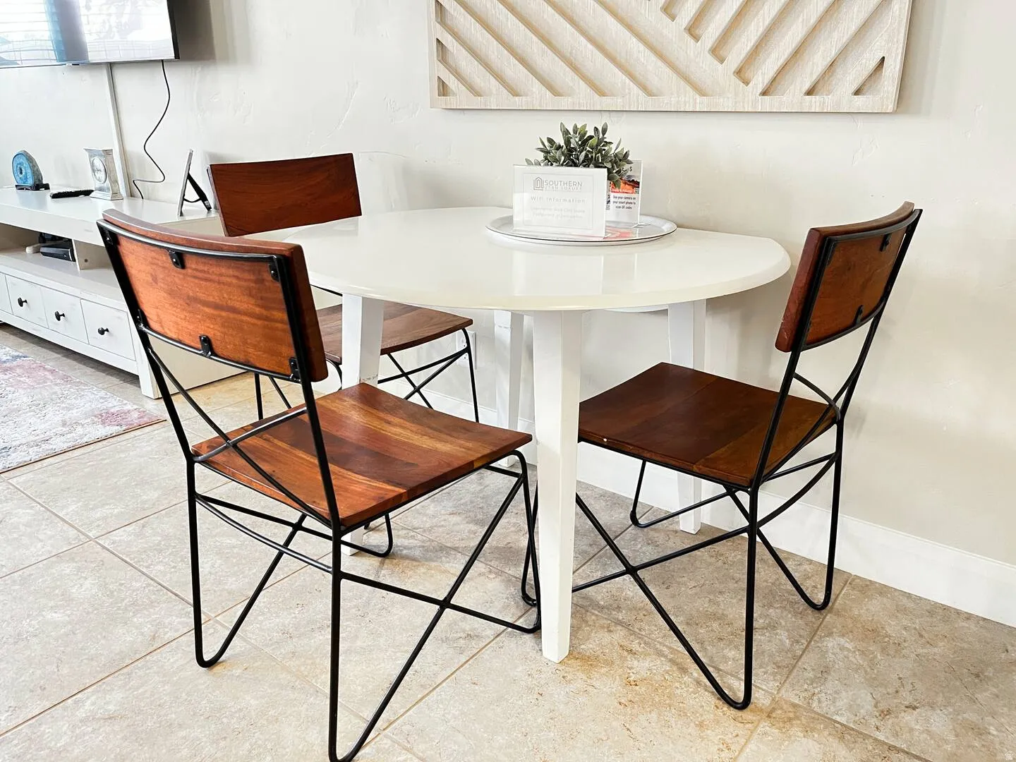 Dining area with light tile patterned flooring and baseboards