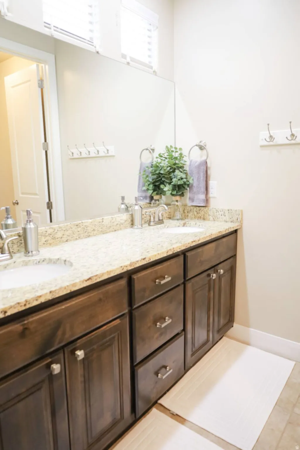 Bathroom featuring double vanity and baseboards