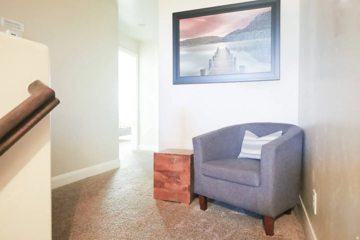 Sitting room featuring light carpet and baseboards