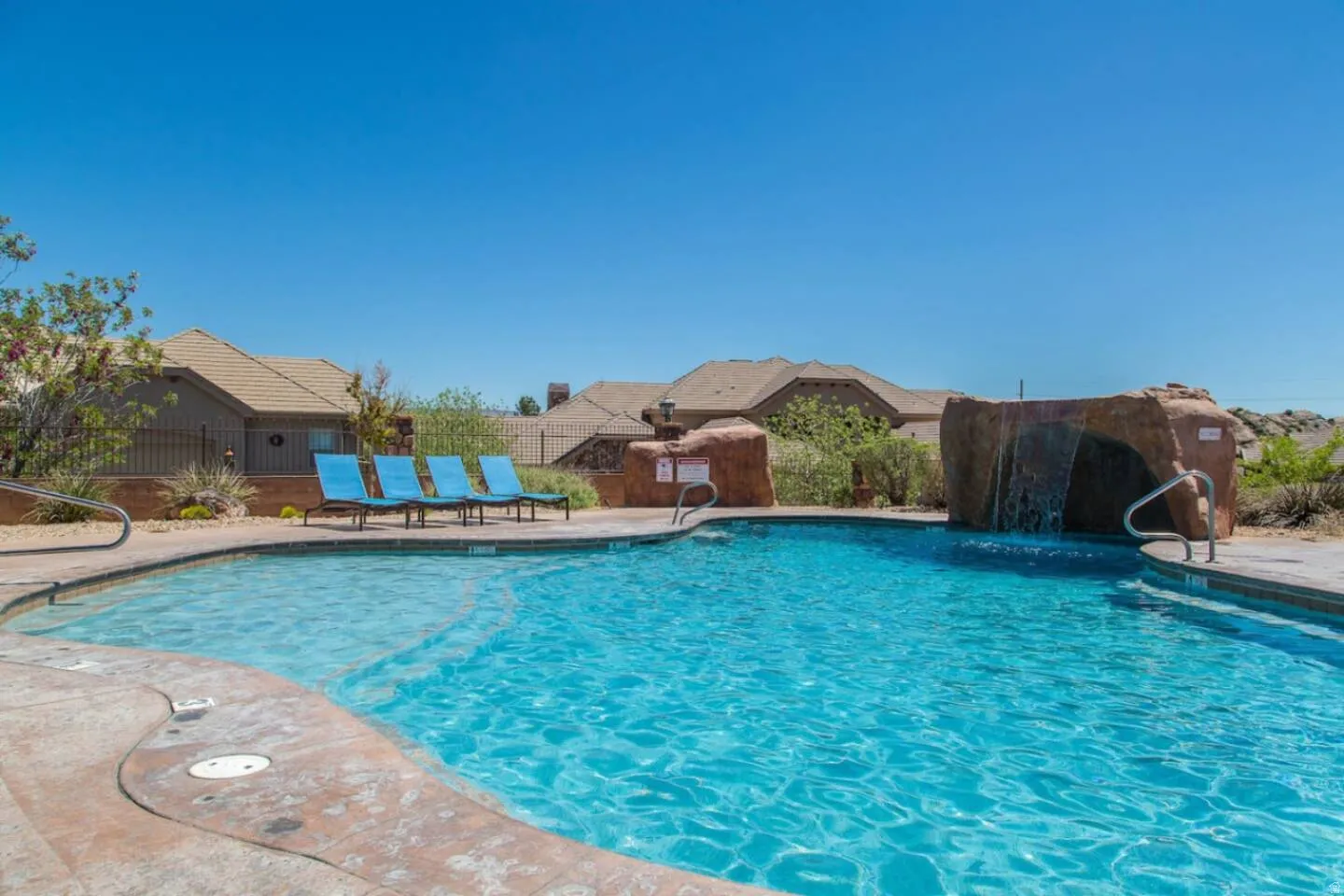 Community pool with a patio