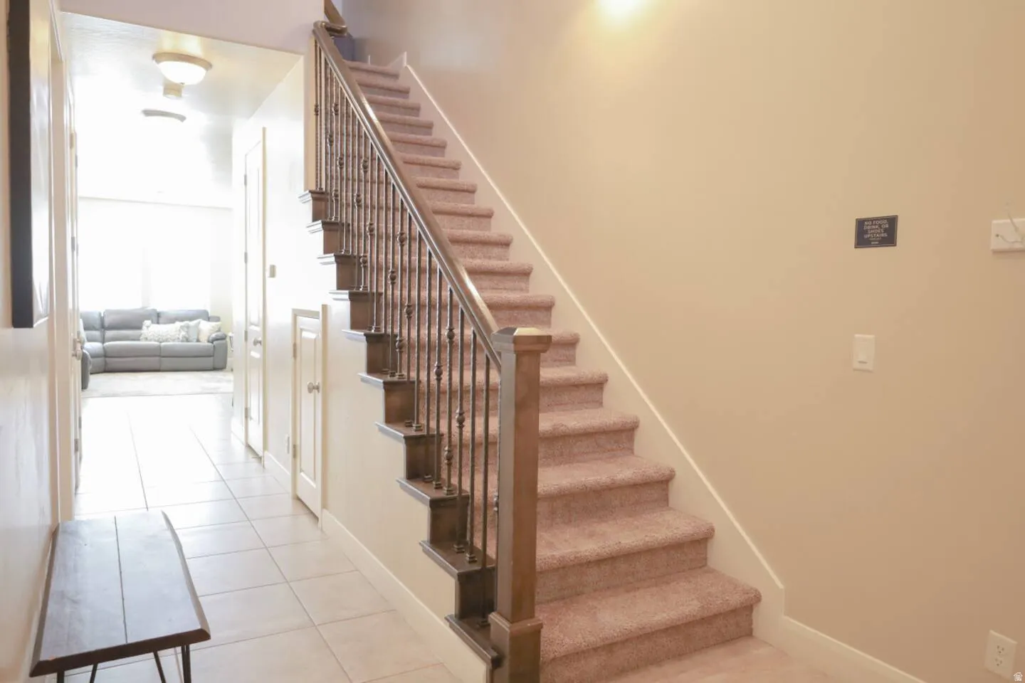 Stairs with tile patterned flooring and baseboards