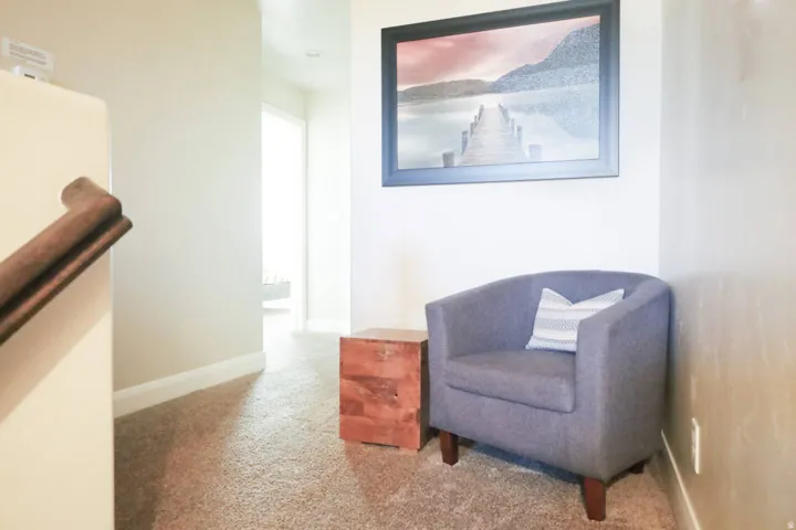 Sitting room featuring light carpet and baseboards