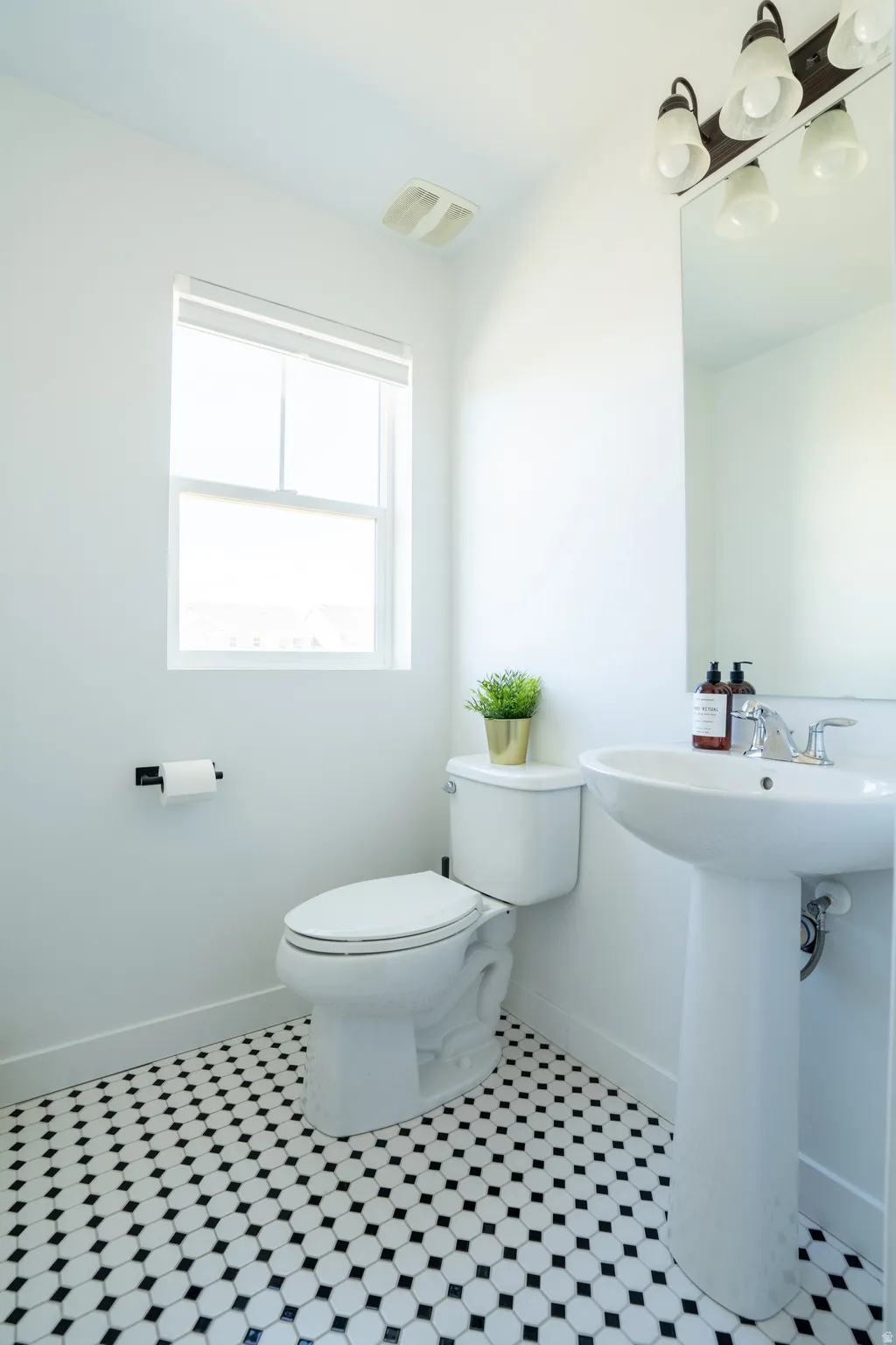 Half bathroom featuring light tile patterned flooring